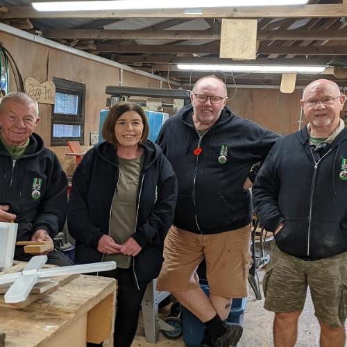 Claire Grant with staff and service users in the workshop at Dig In